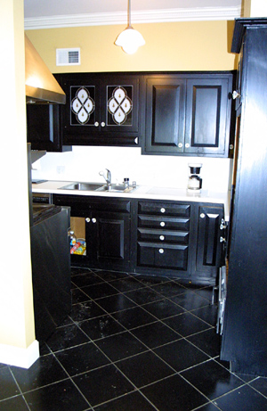 black kitchen cabinets and black appliances on In The Home Was The Kitchen The Cabinets Were Black The Floor In Black
